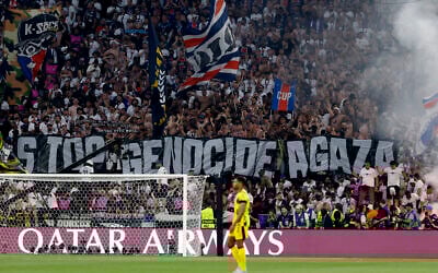 Fans hold a giant banner reading "Stop genocide in Gaza" during the UEFA Champions League final soccer match between Paris Saint-Germain (PSG) and Inter Milan in Munich, southern Germany, on May 31, 2025. (Odd Andersen / AFP)