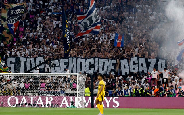 Fans hold a giant banner reading "Stop genocide in Gaza" during the UEFA Champions League final soccer match between Paris Saint-Germain (PSG) and Inter Milan in Munich, southern Germany, on May 31, 2025. (Odd Andersen / AFP) Fans hold a giant banner reading "Stop genocide in Gaza" during the UEFA Champions League final soccer match between Paris Saint-Germain (PSG) and Inter Milan in Munich, southern Germany, on May 31, 2025. (Odd Andersen / AFP)