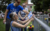 People place flowers and an Israeli flag at the site of a deadly attack outside the Boulder County Courthouse on June 2, 2025 in Boulder, Colorado. (Chet Strange / Getty Images via AFP)
