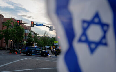 An Israeli flag is fixed to a street sign as police stand by off Pearl Street on the scene of an attack on demonstrators calling for the release of Israeli hostages held in Gaza, in Boulder, Colorado, on June 1, 2025. (Eli Imadali / AFP)
