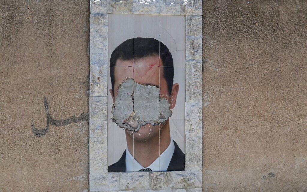 A defaced portrait of Syria's ousted president Bashar al-Assad hangs on a wall in the capital Damascus on June 2, 2025. (LOUAI BESHARA / AFP) A defaced portrait of Syria's ousted president Bashar al-Assad hangs on a wall in the capital Damascus on June 2, 2025. (LOUAI BESHARA / AFP)