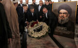 Iran's Foreign Minister Abbas Araghchi lays a wreath of flowers at the grave of slain Lebanese Hezbollah Leader Hassan Nasrallah, who was killed in an Israeli airstrike in September 2024, at his mausoleum in Beirut's southern suburbs on June 3, 2025. (Anwar AMRO / AFP)