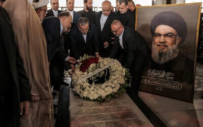 Iran's Foreign Minister Abbas Araghchi lays a wreath of flowers at the grave of slain Lebanese Hezbollah Leader Hassan Nasrallah, who was killed in an Israeli airstrike in September 2024, at his mausoleum in Beirut's southern suburbs on June 3, 2025. (Anwar AMRO / AFP)