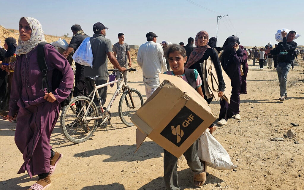 Palestinians walk along a road to receive humanitarian aid packages from the US-backed Gaza Humanitarian Foundation in Rafah, in the southern Gaza Strip, on June 5, 2025. (AFP)
