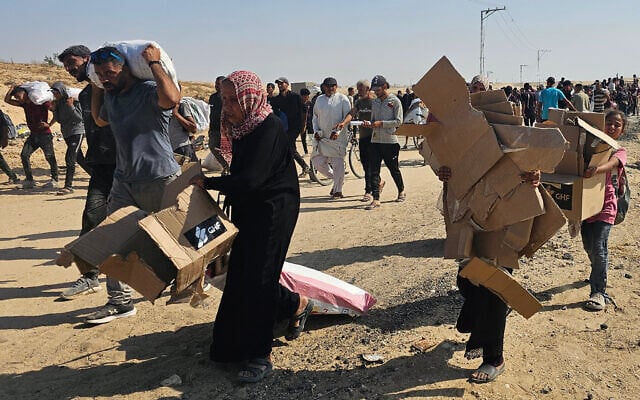 Displaced Palestinians walk along a road to receive humanitarian aid packages from a US-backed foundation in Rafah in the southern Gaza Strip on June 5, 2025. (AFP)
