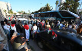 Tunisians gather at a meeting point ahead of the departure of a land convoy to Gaza, in Tunis, Tunisia, June 9, 2025. (FETHI BELAID / AFP)