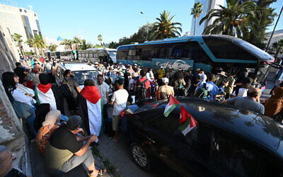 Tunisians gather at a meeting point ahead of the departure of a land convoy to Gaza, in Tunis, Tunisia, June 9, 2025. (FETHI BELAID / AFP)