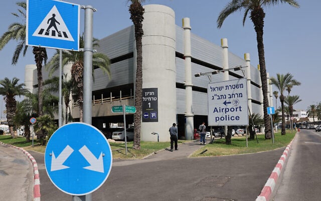 People walk past a sign pointing to the Ben Gurion International Airport police station on June 10, 2025. (Jack Guez/ AFP) People walk past a sign pointing to the Ben Gurion International Airport police station on June 10, 2025. (Jack Guez/ AFP)
