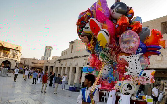 File: A vendor sells balloons outside at the Souq Waqif bazaar in Doha on June 12, 2025. (Karim JAAFAR / AFP)