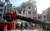 Rescue teams work outside a heavily damaged building following an Israeli strike in the Iranian capital of Tehran, June 13, 2025. (AFP)