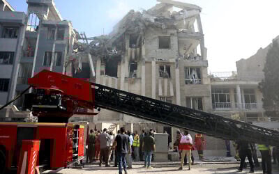 Rescue teams work outside a heavily damaged building following an Israeli strike in the Iranian capital of Tehran, June 13, 2025. (AFP)