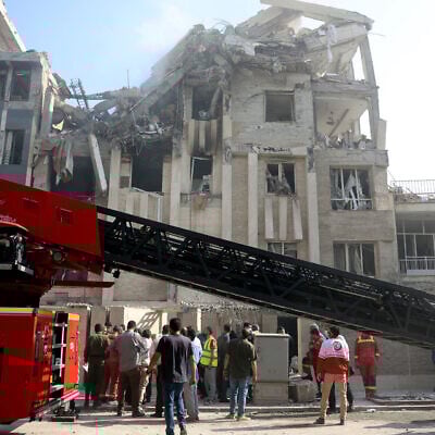 Rescue teams work outside a heavily damaged building following an Israeli strike in the Iranian capital of Tehran, June 13, 2025. (AFP)