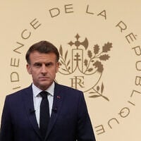 French President Emmanuel Macron arrives to hold a press conference at the Elysee Paslace in Paris on June 13, 2025, after Israel launched a wave of strikes across Iran. (Michel Euler / POOL / AFP)