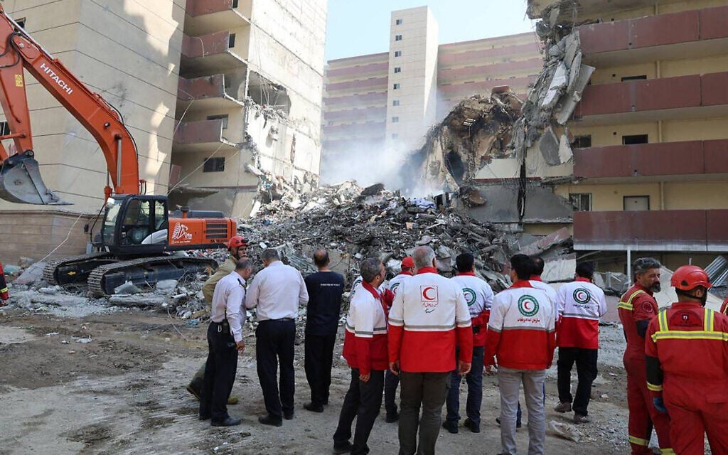 Iranian Red Crescent volunteers gathered in front of a building destroyed in an Israeli strike in Tehran, June 14, 2025. (Iranian Red Crescent / AFP)