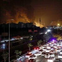 Vehicles jam a highway as a fire blazes nearby in the oil depots of Shahran, northwest of Tehran, Iran, on June 15, 2025. (Atta Kenare/AFP)