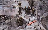 Responders work amid building rubble following a strike by an Iranian missile in the city of Bat Yam, south of Tel Aviv, early on June 15, 2025.  (Jack GUEZ / AFP)