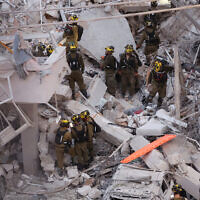 Responders work amid building rubble following a strike by an Iranian missile in the city of Bat Yam, south of Tel Aviv, early on June 15, 2025.  (Jack GUEZ / AFP)