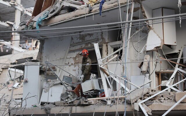 A responder works in a damaged building following a strike by an Iranian missile in the city of Bat Yam, south of Tel Aviv, early on June 15, 2025. (Jack GUEZ / AFP) A responder works in a damaged building following a strike by an Iranian missile in the city of Bat Yam, south of Tel Aviv, early on June 15, 2025. (Jack GUEZ / AFP)