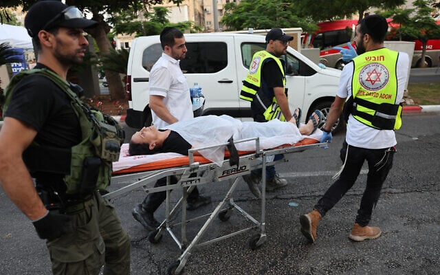 Responders wheel a person on a stretcher following a strike by an Iranian missile in the city of Bat Yam, south of Tel Aviv, early on June 15, 2025.  (Jack GUEZ / AFP)