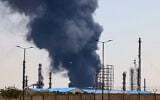 A plume of heavy smoke and fire rise over an oil refinery in southern Tehran, after it was hit in an overnight Israeli strike, on June 15, 2025. (Photo by ATTA KENARE / AFP)