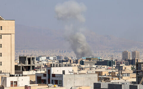 Smoke billows following an explosion in central Tehran on June 15, 2025. Iranian media said an Israeli strike hit the Tehran police headquarters in the city center. (Photo by Atta KENARE / AFP)