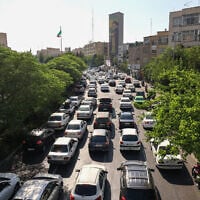 Vehicles wait in traffic as people get out of Tehran through an artery in the city's west on June 15, 2025. (Atta Kenare/AFP)
