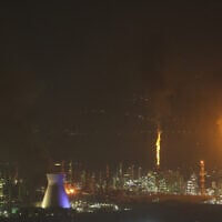 Flames and smoke billow after an Iranian missile struck an oil refinery in Haifa, northern Israel, early June 16, 2025. (Ahmad GHARABLI / AFP)