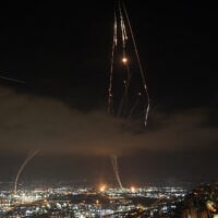 Israeli air defense systems are activated to intercept Iranian missiles over Haifa on June 16, 2025. (Ahmad Gharabli/AFP)