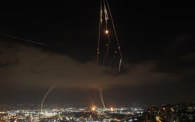 Israeli air defense systems are activated to intercept Iranian missiles over Haifa on June 16, 2025. (Ahmad Gharabli/AFP)