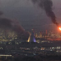 Smoke billows from a missile impact site in the northern city of Haifa on June 16, 2025, where three people were killed in a strike on the Bazan oil refinery complex. (Ahmad Gharabli/AFP)