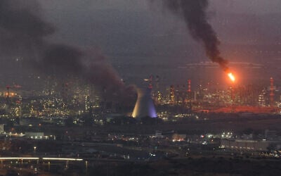 Smoke billows from the site of a missile hit in the northern city of Haifa on June 16, 2025, where three people were killed in an Iranian strike on the Bazan oil refinery complex. (Ahmad Gharabli/AFP)