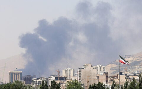 Smoke billows for the second day from the Shahran oil depot, northwest of Tehran, on June 16, 2025. (ATTA KENARE / AFP)