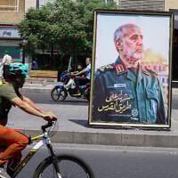 A poster of slain Iranian Islamic Revolutionary Guard Corps (IRGC) commander Gholam Ali Rashid, killed in an Israeli strike, is set up at a Tehran square on June 16, 2025. (ATTA KENARE / AFP)