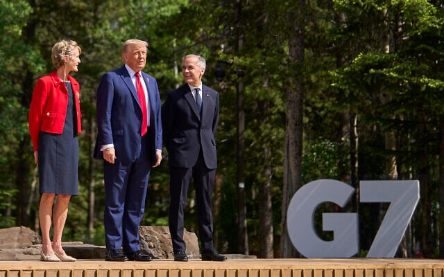 Canadian Prime Minister Mark Carney (R) and his wife Diana Fox Carney (L) greet US President Donald Trump during an arrival ceremony at the Group of Seven (G7) Summit at the Pomeroy Kananaskis Mountain Lodge in Kananaskis, Alberta, Canada on June 16, 2025. (Geoff Robins / AFP) Canadian Prime Minister Mark Carney (R) and his wife Diana Fox Carney (L) greet US President Donald Trump during an arrival ceremony at the Group of Seven (G7) Summit at the Pomeroy Kananaskis Mountain Lodge in Kananaskis, Alberta, Canada on June 16, 2025. (Geoff Robins / AFP)