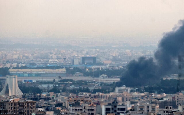 Smoke billows from a site near the Azadi Tower in central Tehran on June 16, 2025. (ATTA KENARE / AFP)