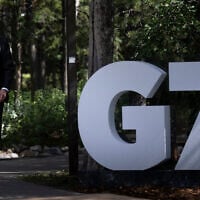 Germany's Chancellor Friedrich Merz arrives to be greeted by Canada's Prime Minister Mark Carney at the Group of Seven (G7) Summit at the Pomeroy Kananaskis Mountain Lodge in Kananaskis, Alberta, Canada, on June 16, 2025. (Brendan Smialowski / AFP)
