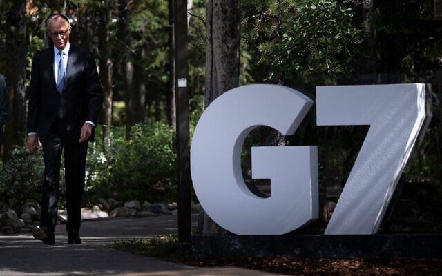 Germany's Chancellor Friedrich Merz arrives to be greeted by Canada's Prime Minister Mark Carney at the Group of Seven (G7) Summit at the Pomeroy Kananaskis Mountain Lodge in Kananaskis, Alberta, Canada, on June 16, 2025. (Brendan Smialowski / AFP)