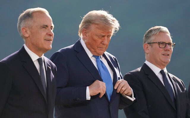 (L-R) Canadian Prime Minister Mark Carney, US President Donald Trump and British Prime Minister Keir Starmer pose for a photo during the Group of Seven (G7) Summit at the Kananaskis Country Golf Course in Kananaskis, Alberta, Canada on June 16, 2025. (Photo by Geoff Robins / AFP)