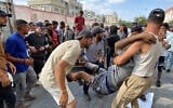 Palestinians transport a man who was allegedly injured by Israeli fire while waiting near a food aid center into Khan Younis' Nasser Hospital in the southern Gaza Strip on June 17, 2025. (AFP)