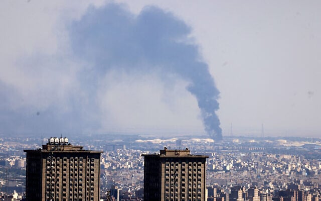 Smoke billows in the distance from an oil refinery following an Israeli strike on the Iranian capital Tehran on June 17, 2025. (ATTA KENARE / AFP) Smoke billows in the distance from an oil refinery following an Israeli strike on the Iranian capital Tehran on June 17, 2025. (ATTA KENARE / AFP)