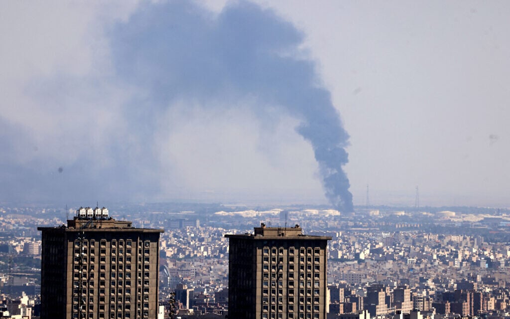 Smoke billows in the distance from an oil refinery following an Israeli strike on the Iranian capital Tehran on June 17, 2025. (ATTA KENARE / AFP) Smoke billows in the distance from an oil refinery following an Israeli strike on the Iranian capital Tehran on June 17, 2025. (ATTA KENARE / AFP)