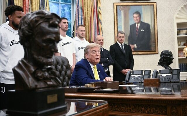 US President Fonald Trump speaks to the press in the Oval Office of the White House as members of Italian soccer club Juventus pay a visit in Washington, DC, on June 18, 2025.(Photo by Brendan SMIALOWSKI / AFP)