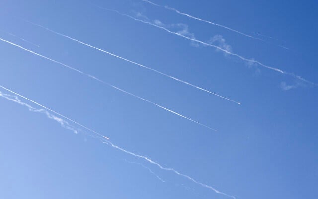 Missile trails are seen in the sky above the coastal city of Netanya amid a fresh barrage of Iranian missile attacks on June 19, 2025 (JACK GUEZ / AFP)