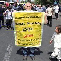 An Iranian carries a placard calling for the destruction of Israel during a rally in Tehran on June 20, 2025.  (Photo by AFP)