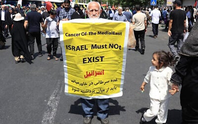 An Iranian carries a placard calling for the destruction of Israel during a rally in Tehran on June 20, 2025.  (Photo by AFP)
