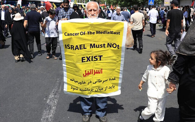 An Iranian carries a placard calling for the destruction of Israel during a rally in Tehran on June 20, 2025.  (Photo by AFP)