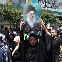 An Iranian carries a portrait of Iran's Supreme Leader Ayatollah Ali Khamenei during an anti-Israeli rally in Tehran on June 20, 2025. (AFP)