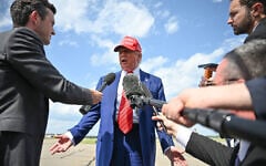 US President Donald Trump speaks to the press upon arrival at Morristown Municipal Airport in Morristown, New Jersey, on June 20, 2025. Trump is heading to his Bedminster golf resort for a MAGA Inc. fundraising dinner. (Photo by Mandel NGAN / AFP)
