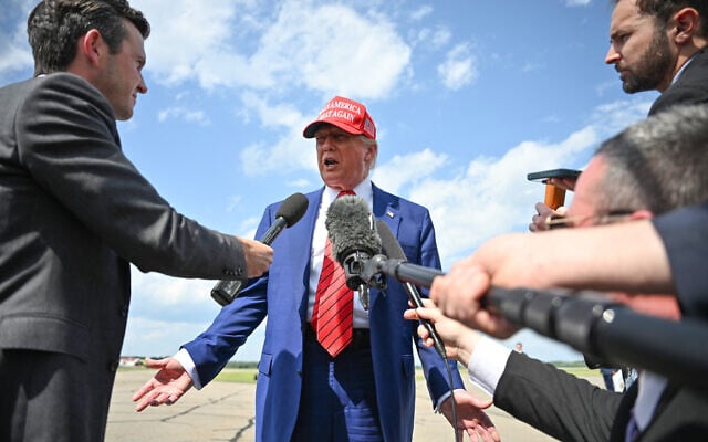 US President Donald Trump speaks to the press upon arrival at Morristown Municipal Airport in Morristown, New Jersey, on June 20, 2025. Trump is heading to his Bedminster golf resort for a MAGA Inc. fundraising dinner. (Photo by Mandel NGAN / AFP)