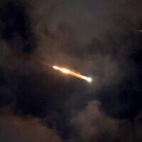 Missile trails are seen in the sky above Netanya amid an Iranian missile attack on June 21, 2025 (JACK GUEZ / AFP)